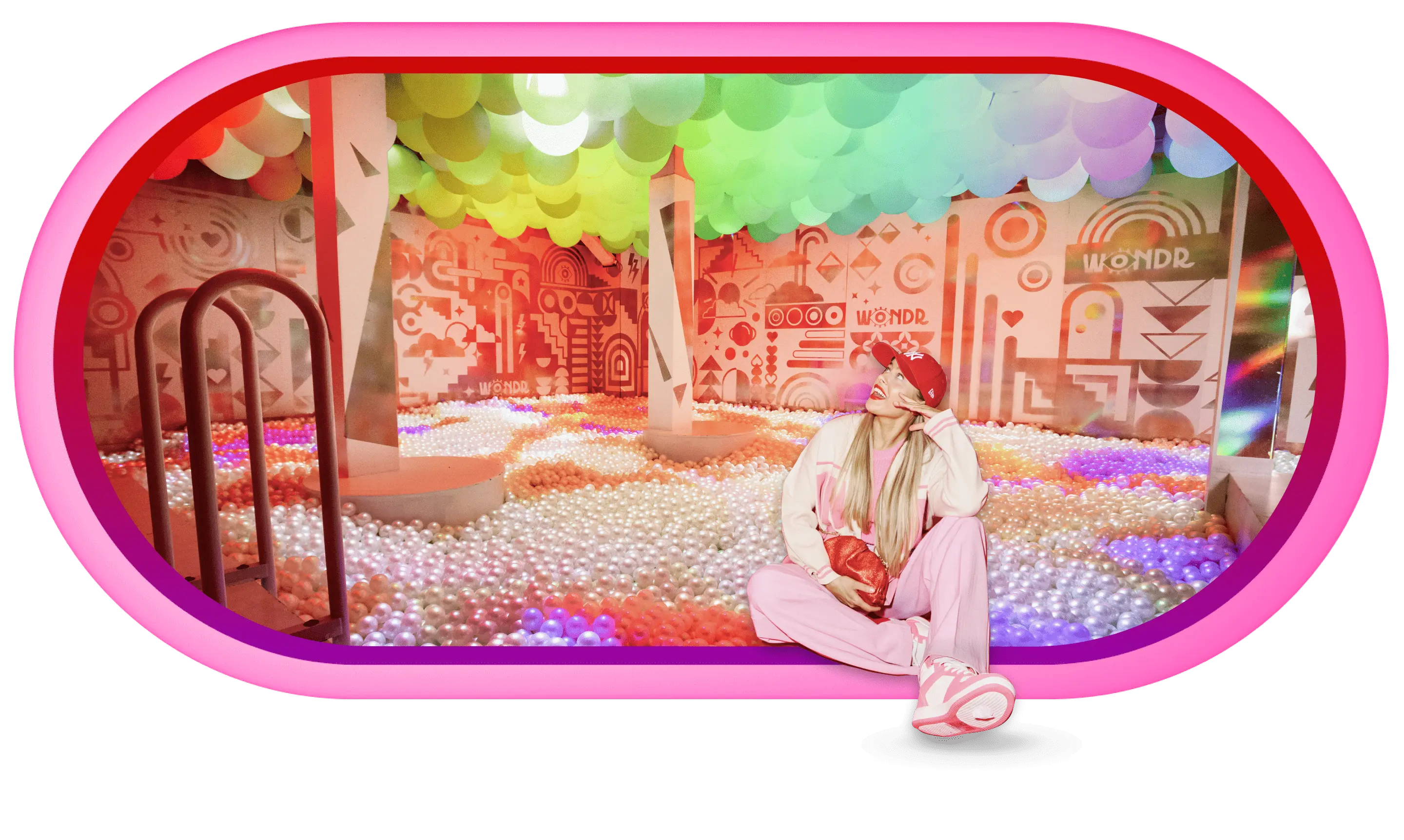 Colorful ball pit room with rainbow decorations and lights