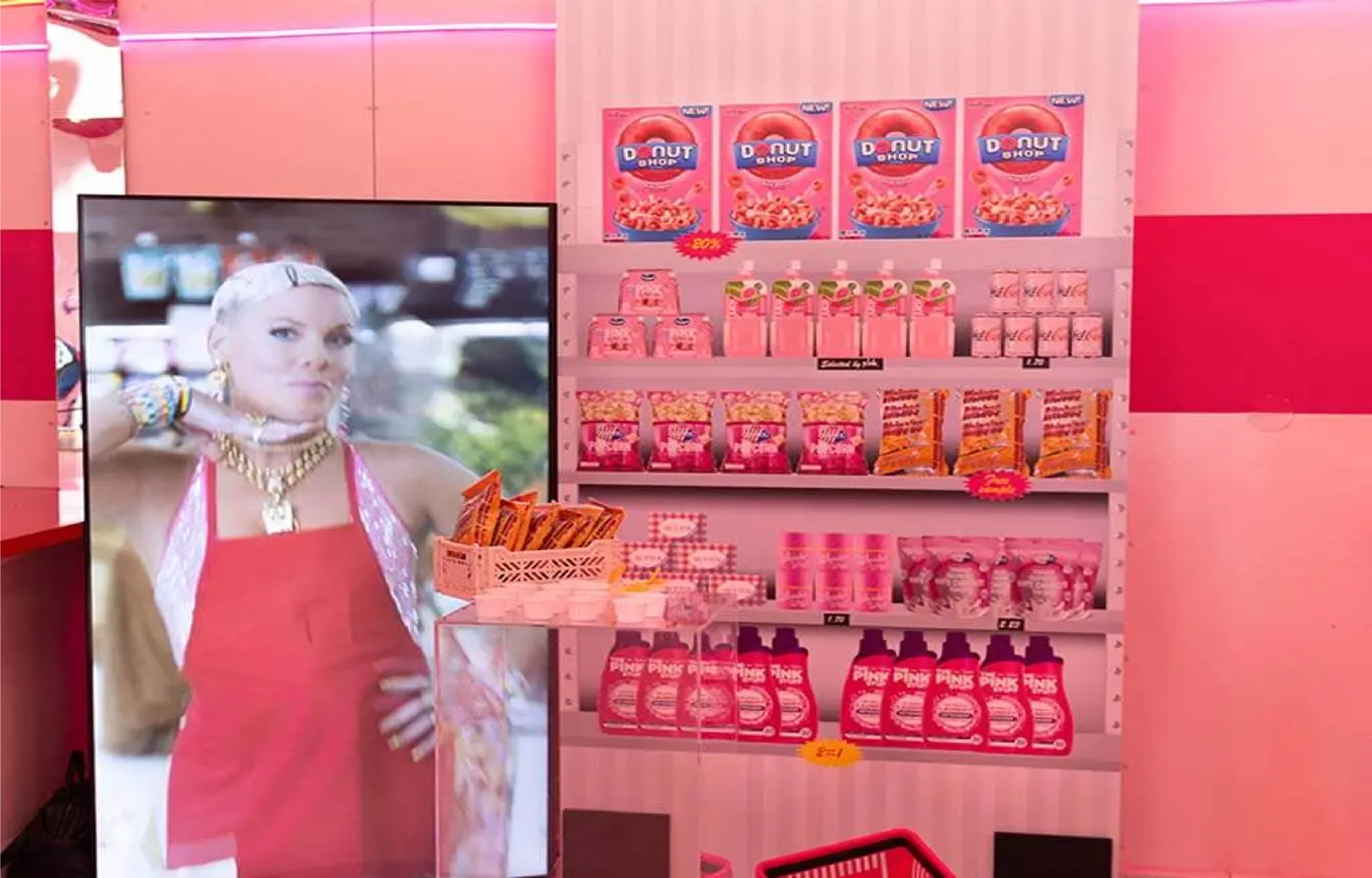 Product display wall in a pink-themed store interior